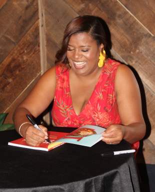 Althea Brown, happily signs a copy of her cookbook, “Caribbean Paleo” during a successful book-signing and tasting at CAVA Loft, Brooklyn, on Oct. 13.
