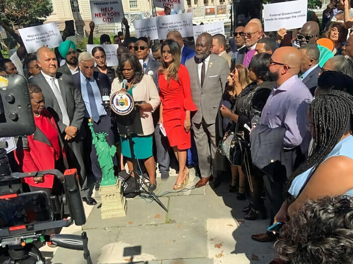 Brooklyn Democratic Party Chair Rodneyse Bichotte Hermelyn with elected officials and clergy leaders at a rally in front of City Hall calling for federal aid for the migrant crisis.