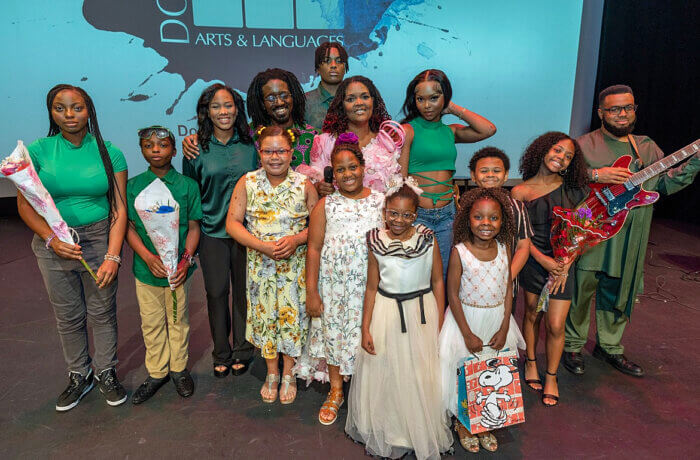 Students pose after their yearly performance show with the founder of DoReMi Arts & Languages, Esther Loiseau.