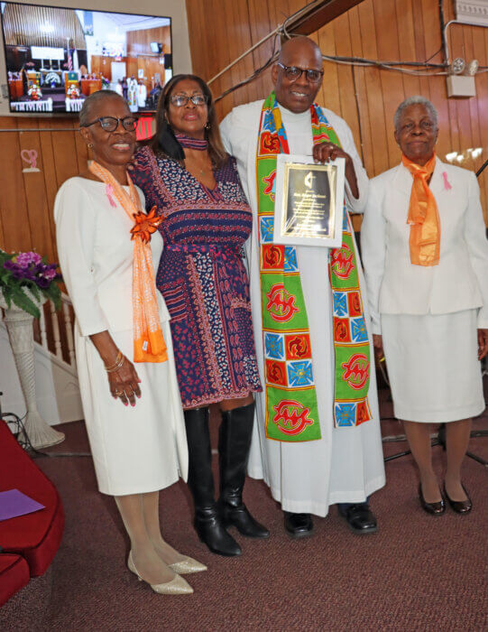 Pastor the Rev. Roger Jackson receives award, flanked by his wife, First Lady Sis. Kim, to his right. Others in photo, Sis. Marlene Ferguson, left, and Sis. Doreen Thomas.