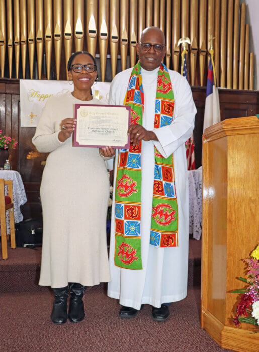 Council Member Rita Joseph presents a citation to Pastor, the Rev. Roger Jackson.