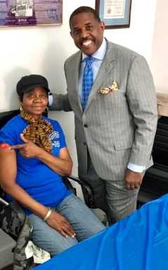 A resident shows off her flu shot, next to Senator Kevin Parker who organized a two-day flu shot outreach on Oct. 20 & 21.