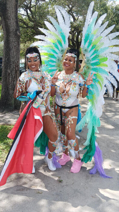 Masqueraders proudly display the Trinidad and Tobago national flag as part of her costume