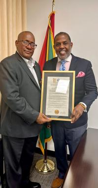 NYS Senator Kevin Parker (right) presents a proclamation to Consul General of Guyana to New York Michael E. Brotherson, at his Manhattan Office.