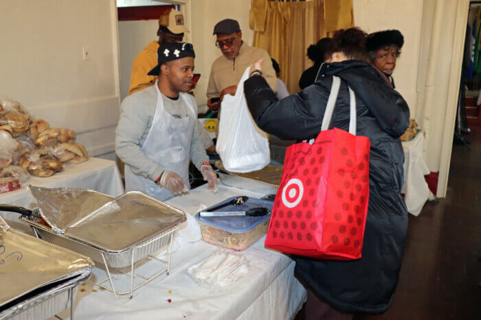 A homeless woman gets a Thanksgiving meal.