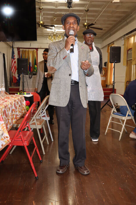 Dep. Grand Master Glenver R. Jones addresses Thanksgiving Dinner, with Hon. Myrthland Ince in background.