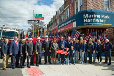 Councilwoman Mercedes Narcisse with firefighters and family members of Steven Pollard during the unveiling and co-naming of a street in his honor.