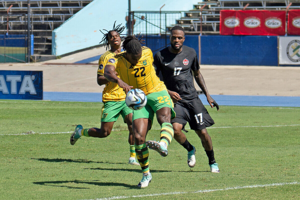 KINGSTON, JAMAICA Nov. 17: Gregory Leigh #22 of Jamaica kicks the ball and Cyle Larin #17 of Canada during the League A Quarter Finals match between Jamaica and Canada in the Concacaf Nations League, held at the National Stadium, Kingston, Jamaica.