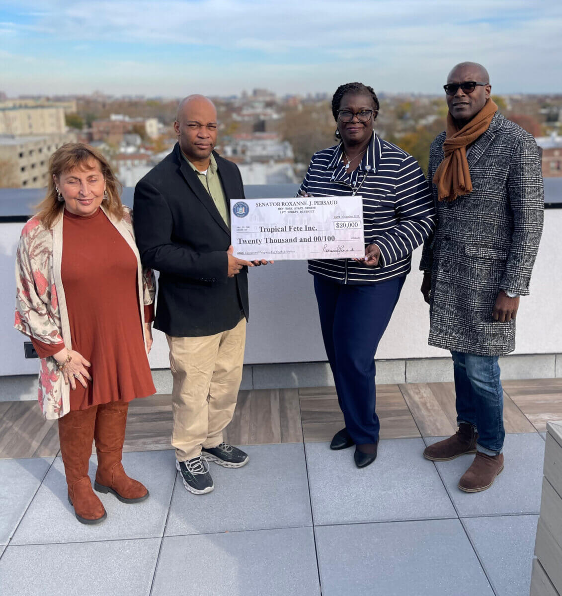 Senator Roxanne Persaud presenting a check for $20,000.00 to Mr. Alton Aimable - President, and two board members Keran Deterville and Patricia Meschin (left).