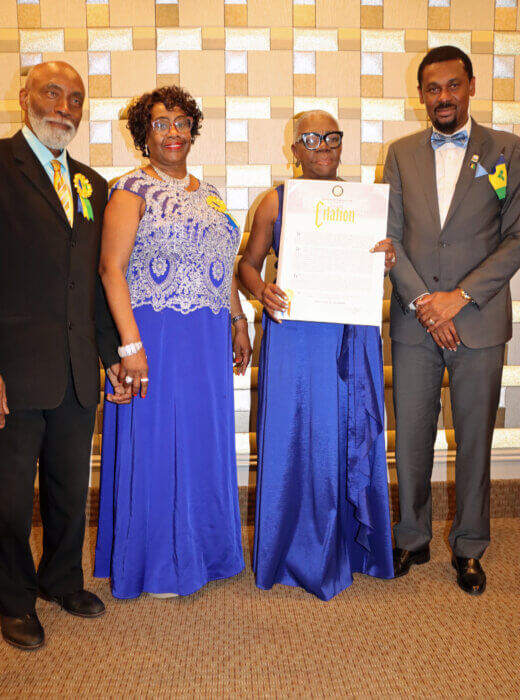Celia Bramble, receives proclamation Ancilla Friday, second from right, on behalf of Mayor Eric Adams, flanked by Mrs. Friday's husband, Crispin Friday, left, and SVG Consul General Rondy "Luta" McIntosh, right.