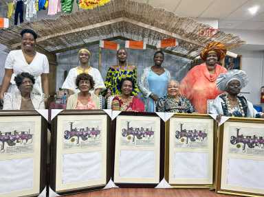 Glenda Cadogan, creator and founder of Yesterday's Children, fifth from left standing, joins honorees at the organization's 13th Annual Awards gala.