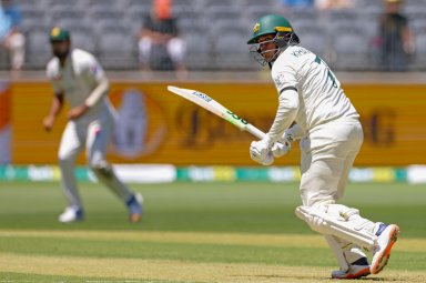 Usman Khawaja of Australia bats on the first day of the first cricket test between Australia and Pakistan in Perth, Australia, Thursday, Dec. 14, 2023. Khawaja wasn't allowed to wear shoes branded with an “all lives are equal” humanitarian message, so he wore a black arm band instead on Day 1 of the series-opening cricket test against Pakistan.