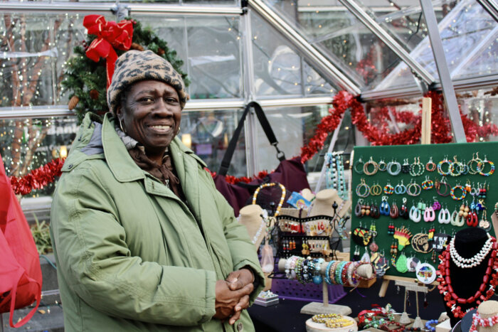 Barbados native, Heather, showcases her collection of Jewelry from her greenhouse booth, at the Bed-Stuy Winter Wonderland Holiday at the intersection of Fulton Street and Marcy Avenue.