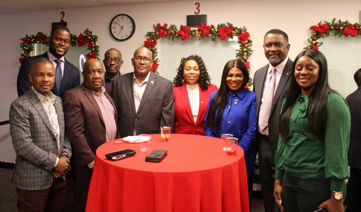Members of the CARICOM Consular Corps, extreme left, back row, Mr. Jeremiah Hyacinth consul general Consulate General of Saint Lucia, front row second from left, Sheldon Peter consul general, Commonwealth of Dominica, Consul General of Guyana to NY, Michael E. Brotherson, Madam Marie Amy Charge d Affaires, consul general of the Republic of Haiti, Mrs. Alsion Wilson, consul general, Consulate General of Jamaica, and Leroy F. Major, Bahamas Consulate General, among other guests, at a Dec. 21 Christmas party at new location, 228 E 45th St., Manhattan.