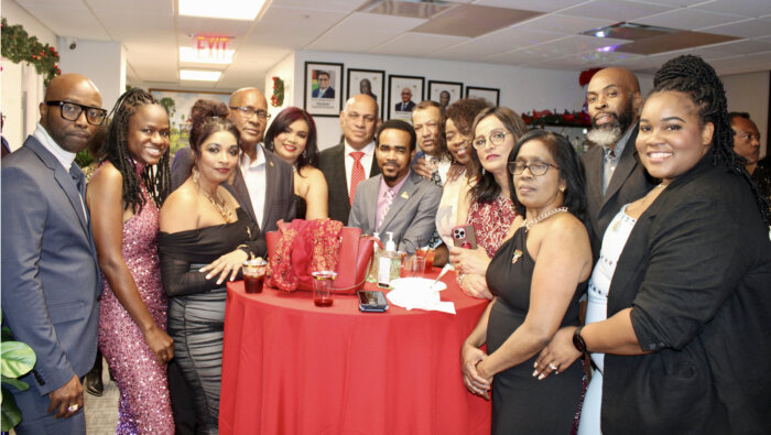 Consul General of Guyana Ambassador Michael E. Brotherson, fourth from left, surrounded by his staff, at a Dec. 21 Christmas party at a new location, 228 E 45th St., Manhattan.