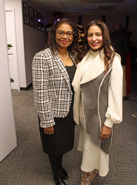 Judge of the Civil Court of New York, Andrea S. Ogle, left and Executive Director at Gracie Mansion Conservancy, Rhonda Benda, celebrate the festive gathering at the Guyana Consulate in Manhattan, on Dec. 21.