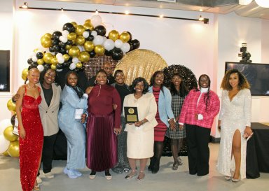 The Lawrence family of seven children whose story from homelessness to nursing school went viral, and caught the attention of People Magazine, and the Sherry Shepherd show, are pictured with their parents, and Assemblywoman Monique Chandler Waterman (left), after being presented with an award at the 2nd Annual AD 58 Community Awards ceremony at the Top Civic Center, in Brooklyn, on Dec. 3.