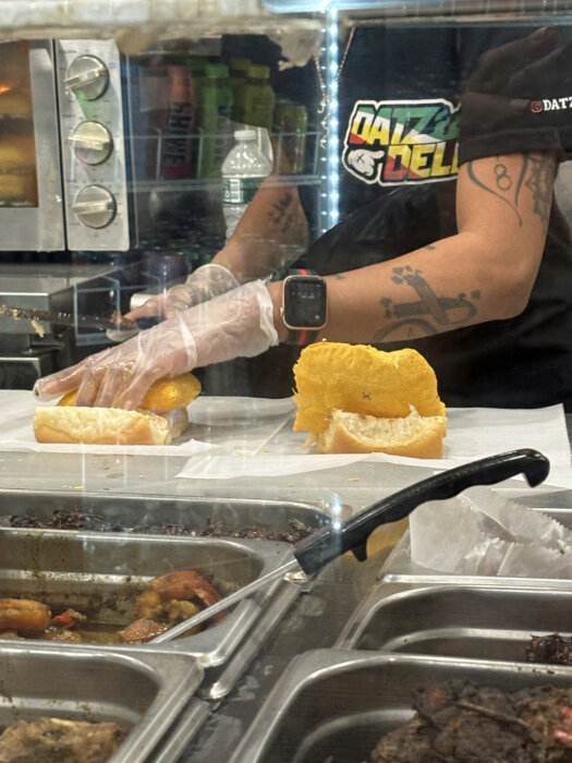 Datz Deli employee preparing the DatMacPatty.