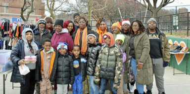 Third from left, second row, Princess Cornneitte, founder of the Brownsville Devine Explosion Arts Program, joins volunteers at a Dec. 23 Christmas Bazaar, at the Love Zone outdoor space.