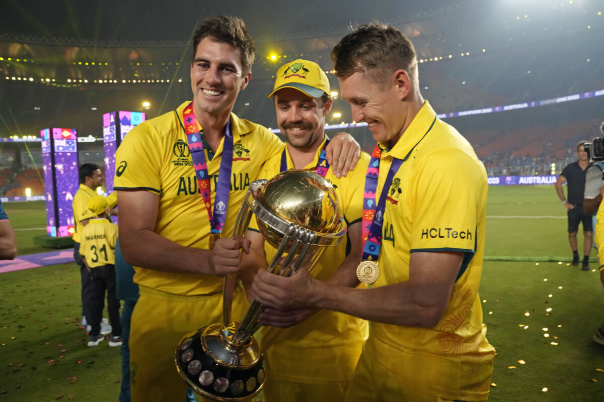 Australia's captain Pat Cummins, Australia's Travis Head and Marnus Labuschagne pose with the trophy after wining the ICC Men's Cricket World Cup final match against India in Ahmedabad, India, Sunday, Nov.19, 2023.