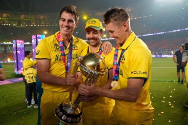 Australia's captain Pat Cummins, Australia's Travis Head and Marnus Labuschagne pose with the trophy after wining the ICC Men's Cricket World Cup final match against India in Ahmedabad, India, Sunday, Nov.19, 2023.
