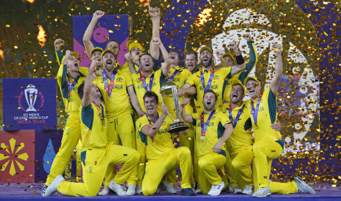 Australian players celebrate with the trophy after winning against India during the ICC Men's Cricket World Cup final match in Ahmedabad, India, Sunday, Nov.19, 2023.