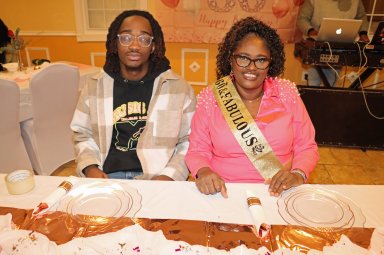 Jamaican Irlene Jones-Brathwaite, with younger son, Donte, at head table.