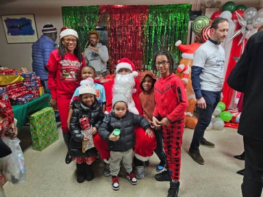 Assemblywoman Monique Chandler-Waterman (left) with Santa and kids.