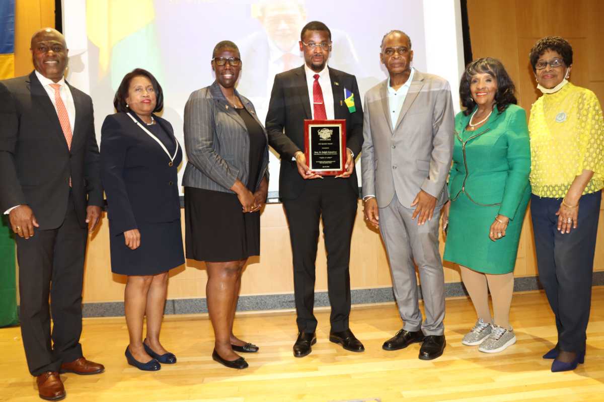 St. Vincent and the Grenadines Consul General to the United States Rondy "Luta" McIntosh, center, receives plague, on behalf of Vincentian Prime Minister Dr. Ralph E. Gonsalves, from Dr. Ken Irish-Bramble, to McIntosh's left, chair of Brooklyn's Medgar Evers College's (MEC) Caribbean Research Center, in June 2023 in commemorating Caribbean-American History Month at MEC. Others in photo from left: Horace Davis, president of Caribbean-American Society of New York; MEC Provost Dr. Antoinette Coleman; Sherrill-Ann Mason-Haywood, director of MEC's Seek Program; Dr. Evelyn Castro, senior advisor to MEC President Dr. Patricia Ramsey; and Anna Walker, representative of the Caribbean-American Chamber of Commerce and Industry (CACCI).