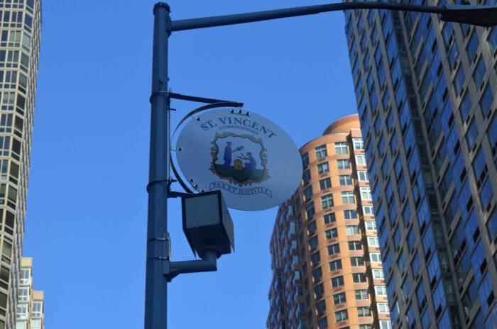 SVG Coat-of-Arms on display on pole on 6th Avenue in Manhattan.