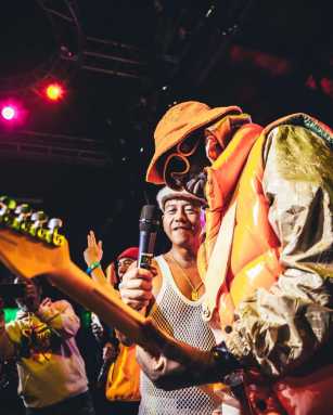 Wyclef Jean salutes Mighty Crown with an electrifying live dubplate at 'World Bash.' Sami-T can be seen in the photo.