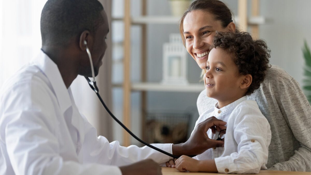 Pediatrician checks the heart of a kid.