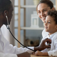 Pediatrician checks the heart of a kid.