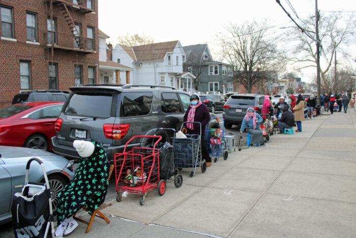 Four lines, consisting of mostly Asylum seekers, gathered overnight for a Saturday, Jan. 6 distribution of groceries from Calvary's Mission Food Pantry in Richmond Hill, Queens.