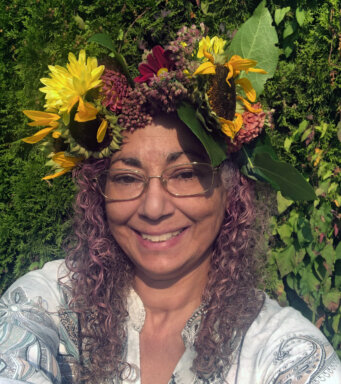 Artist Rose L. Williams with flower headdress.