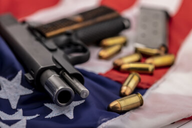 Gun and bullets on an american flag background