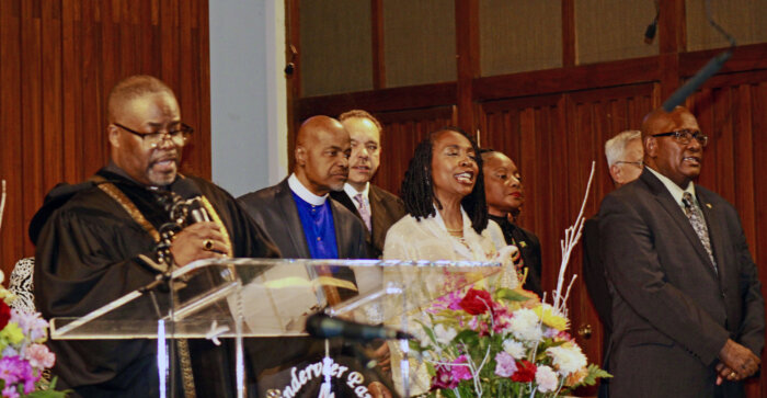 Rev. Melvin Boone, Bishop Davis, Johnathan Locke, Congresswoman Yvette D. Clarke, Rose October, partly hidden, Kishur Seunarine, and Consul General of Guyana to New York, Ambassador Michael Brotherson, on stage at Vanderveer Methodist Church in Brooklyn, on Jan. 22, during a celebration of life for the late Claire Ann Goring, a cultural Icon.