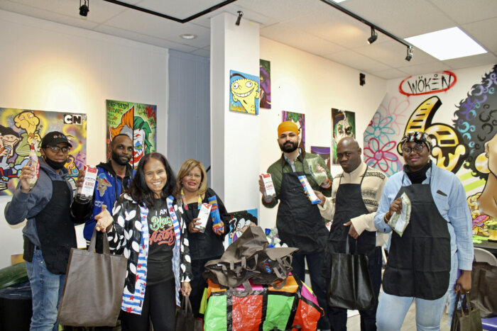 Founder, president of Power of the Soil, Bibi Alli, and Sherry Williams, founder of Together We Serve food pantry pictured in front row, during a food distribution at Twisted N' Brushes. Japneet Singh, candidate for NYS Senate D15, right, is next to Terrance Brummell, while art space owner Anthony Springer, showcases a grocery in the back, with others.