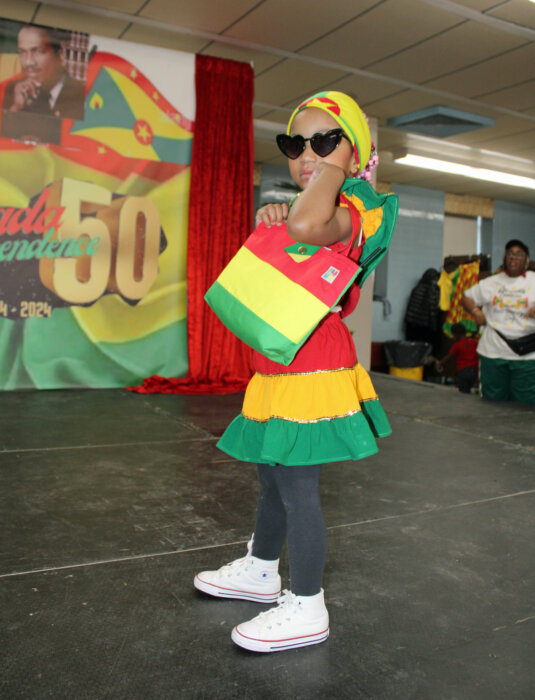 Little Miss Grenada shows off a Grenadian designed handbag during the 50th Golden Jubilee Youth Fiesta fashion parade at Nazareth High School Auditorium in Brooklyn, on Jan.20.