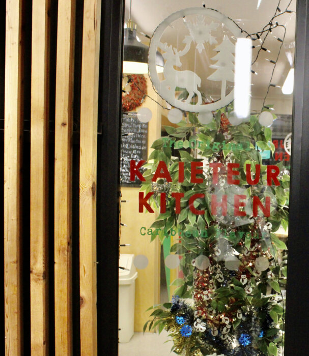 The facade of Kaieteur Kitchen Restaurant, decorated for the Christmas season, is owned and operated by chef Faye Gomes, and located at Castle Square, Elephant Road, London, UK in a second-floor walkup in London's prominent Elephant and Castle Center.