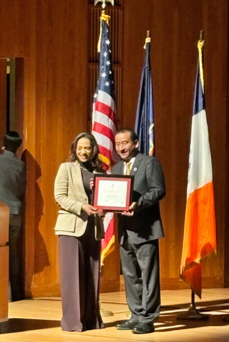 President of Queens College Frank Wu presents the 2024 MLK Award to Jennifer Jones Austin.