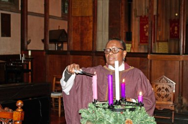 Guyanese born, Reverend Canon Roxanne Eversley, lights a candle in the vast hall of of the historic 109-year-old Holy Innocents Church, in the south London suburb of South Norwood, England, where she served for many years. She will become the first Dean of Cultural Diversity in conjunction with the residentiary role of Canon Librarian at Southwark Cathedral, London, England after a ceremony this month.
