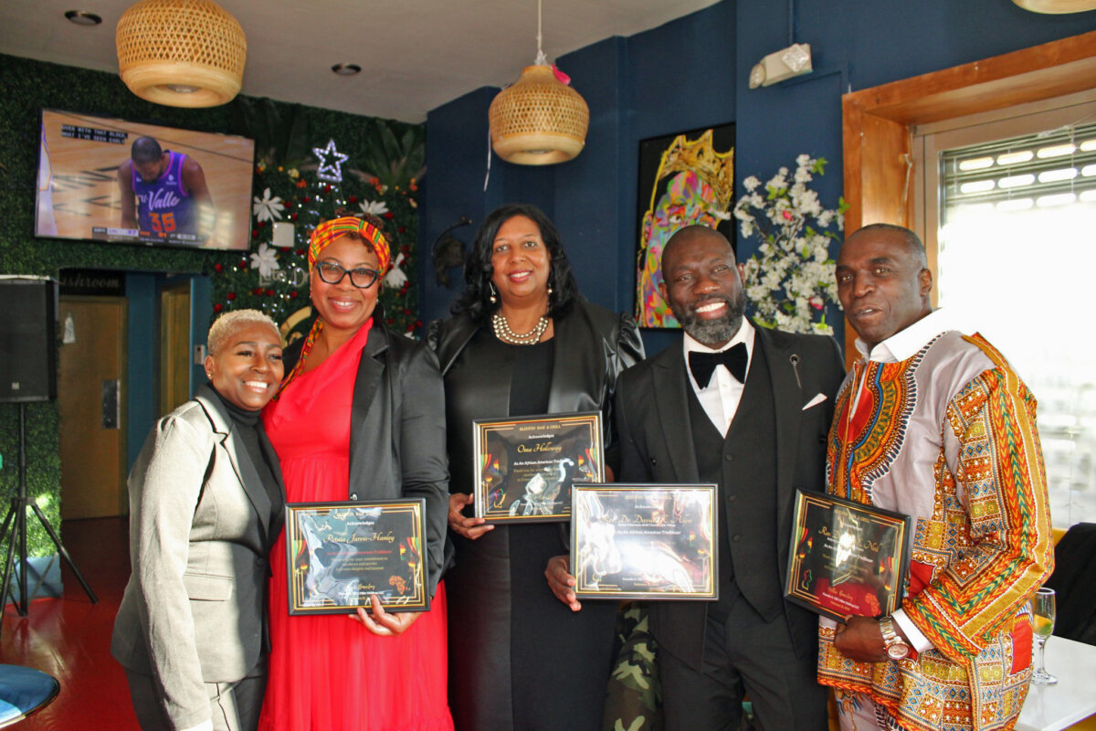 Owner of Bleu Fin Bar & Grill, Hollis Barclay, left, with honorees, Petula Hanley, Democracy Beyond Elections Coalition, manager at the Participatory Budgeting Project, Oma Halloway, chief operations officer of Bridge Street Development Corporation, Reverend Dr. David K. Allen, founder of Epic Village Community Development Corp, and Reverend Dr. Clive E. Neil, pastor of Bedford Central Presbyterian Church, after being honored at the 633 Nostrand Ave., Brooklyn location, Feb. 25.