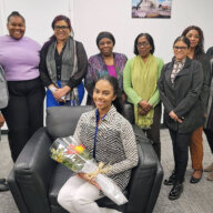 Staff members of the Guyana Consulate NY congratulate Miss Guyana World 2022/23 Andrea King, sitting, during her visit to the diplomatic office 228 E 45th St. in Manhattan.