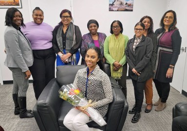 Staff members of the Guyana Consulate NY congratulate Miss Guyana World 2022/23 Andrea King, sitting, during her visit to the diplomatic office 228 E 45th St. in Manhattan.