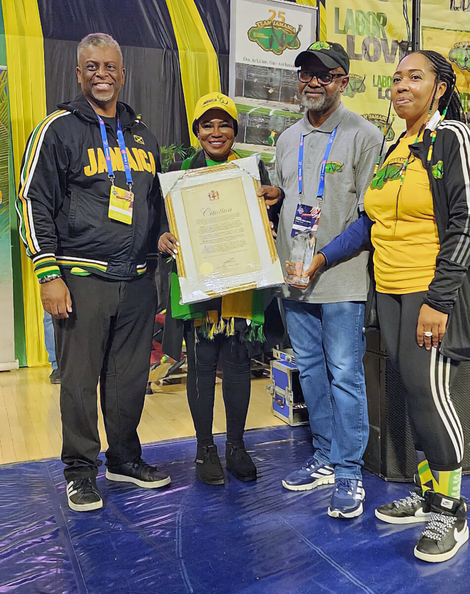 Jamaica Consul General Alsion Wilson presenting award to Irwine Clare. Also in picture are Dr. Anthony Munroe, pesident of BMCC and Stacey Osbourne, of Team Jamaica Bickle.