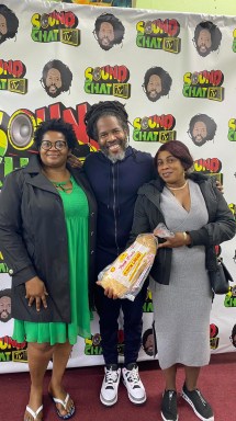 Loyal listeners of Sound Chat Radio are happy to pick up their free Bread & Bun, while meeting their favorite broadcasters (Garfield "Chin" Bourne of Sound Chat Radio - center).