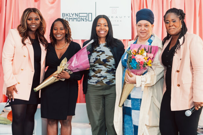 Johanne Brierre (far right) joined City Council Women Farah Louis (far left) and Rita Joseph (center) in recognizing and presenting flowers to unsung community heroes Ritha Louis (2nd left) and Dale Charles (4th from left for their unwavering support in uplifting and supporting black and women owned businesses.