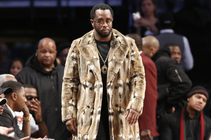 FILE - Sean "Diddy" Combs, wearing a fur coat, walks down the sideline during the second half of an NBA basketball game between the Brooklyn Nets and the New York Knicks, Sunday, March 12, 2017, in New York. 