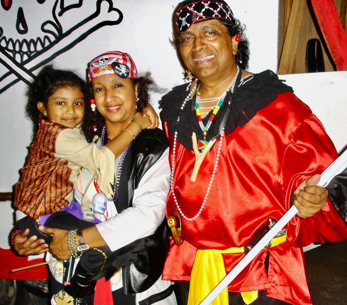 Annabelle DrePaul, at an early age with parents, Ingrid and John "Slingshot" DrePaul after one of their Mashramani presentations in Guyana.